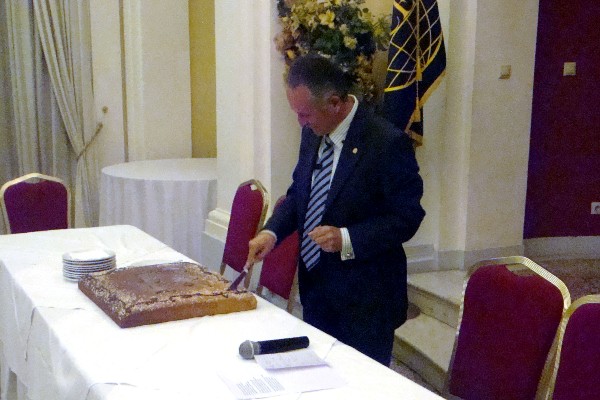 Gen. Leonidas Mazarakis, HAF (Ret.), chapter president, cuts the traditional New Year's cake during the chapter's celebration in February.